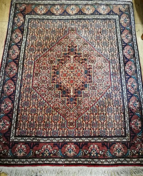 A Persian red ground rug 150 x 123cm